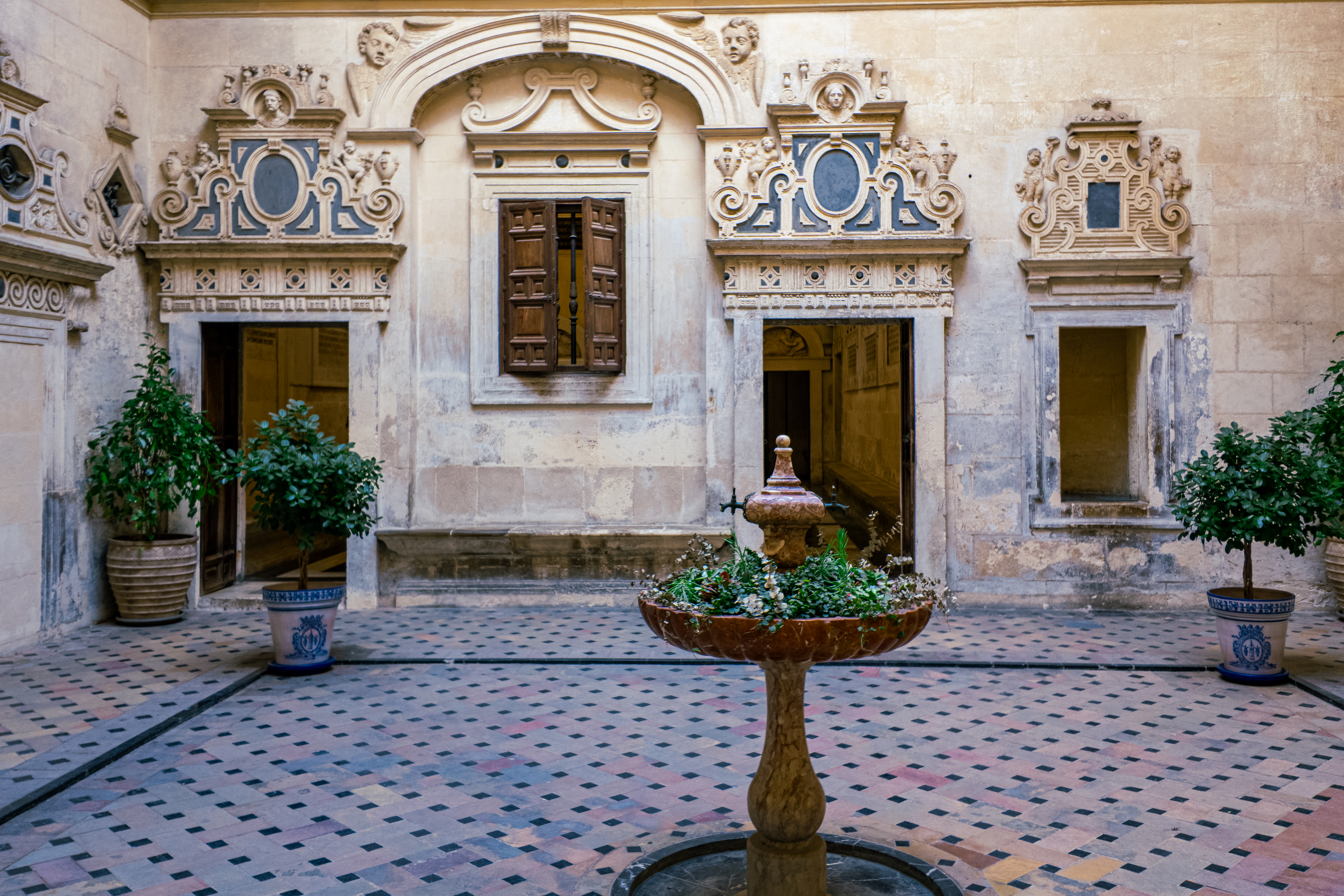 Historic Seville courtyard with a central fountain